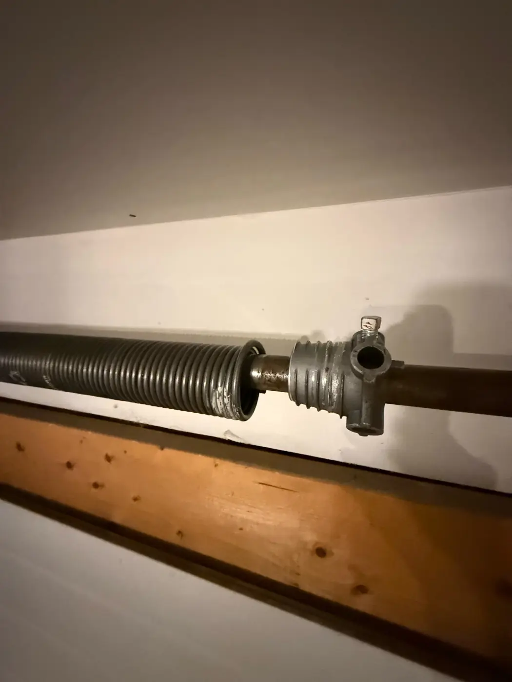 Torsion spring above a garage door, one of the many parts our team replaces
